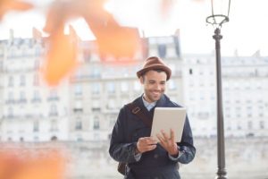 Businessmen using digital tablet along Seine River, Paris, France